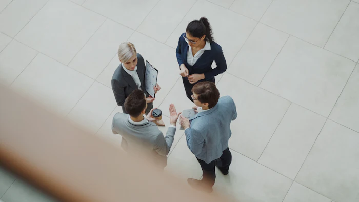 Professionals talking in an office lobby